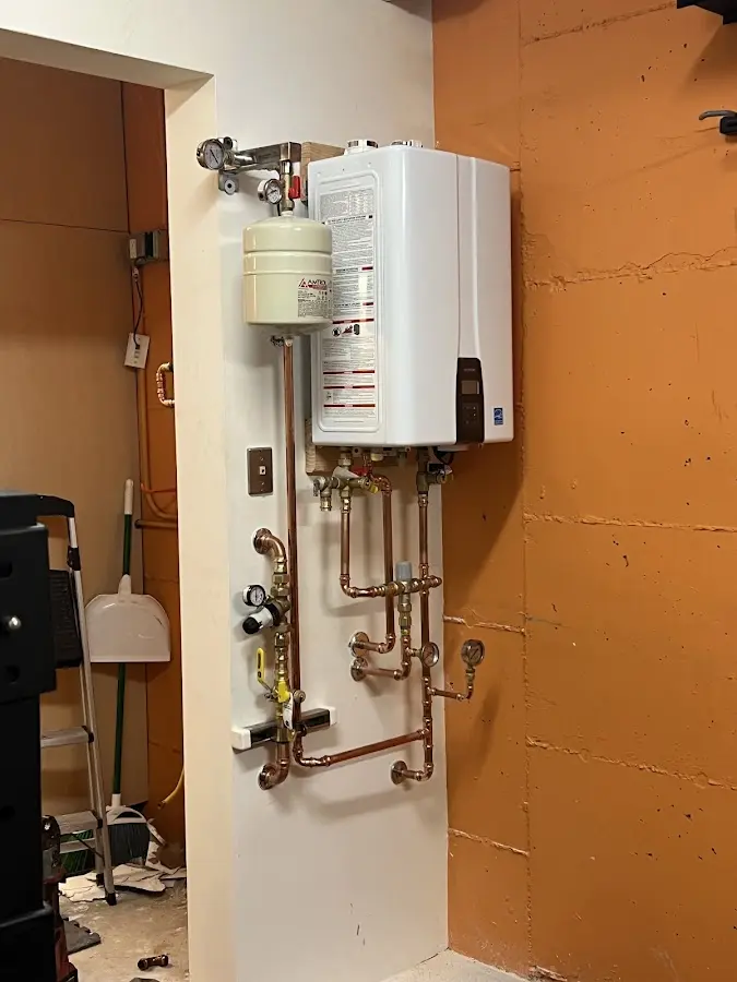 Plumbing technician inspecting water heater connections in Los Altos Hills